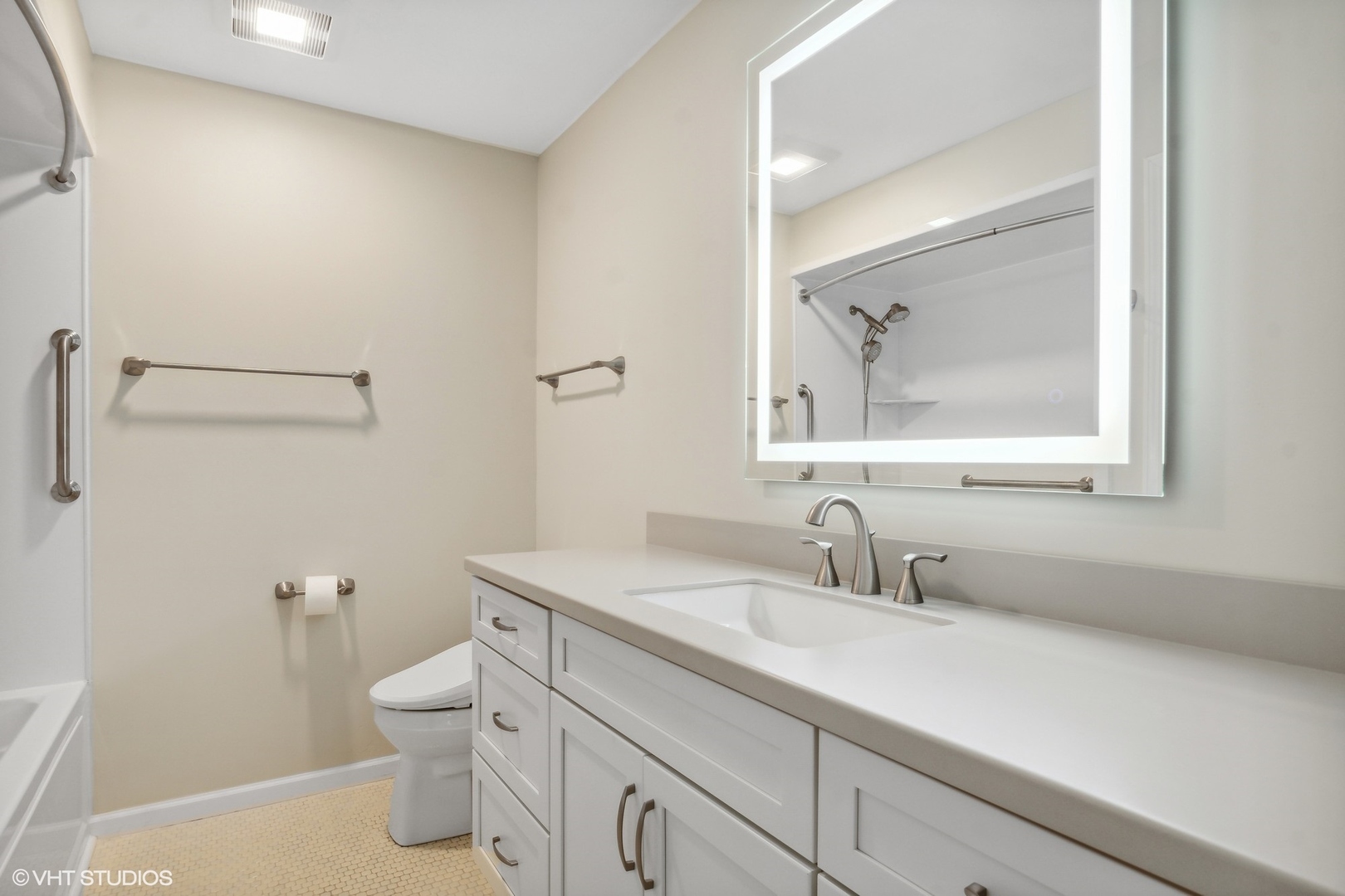 1175 Lake Cook Road, Unit 204 Northbrook, IL 60062 - Photo 11 of 20 a bathroom with a toilet a sink and mirror