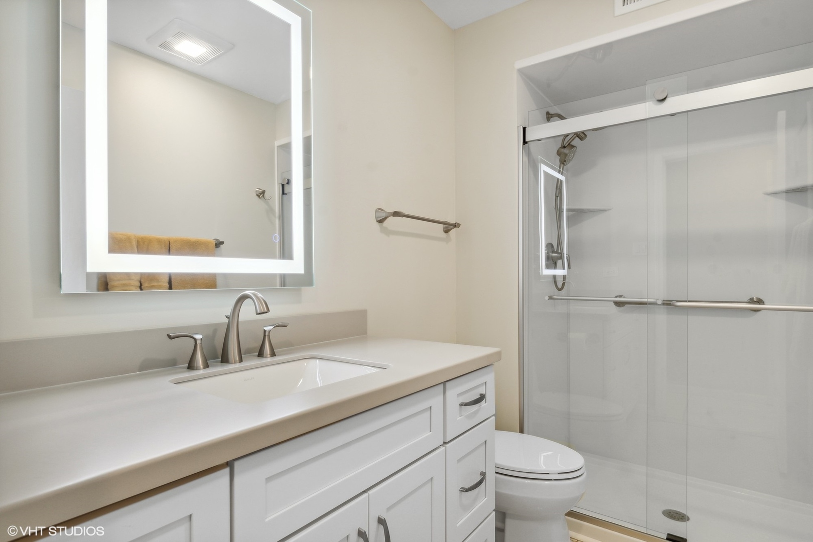 1175 Lake Cook Road, Unit 204 Northbrook, IL 60062 - Photo 14 of 20 a bathroom with a sink a toilet a shower and a mirror