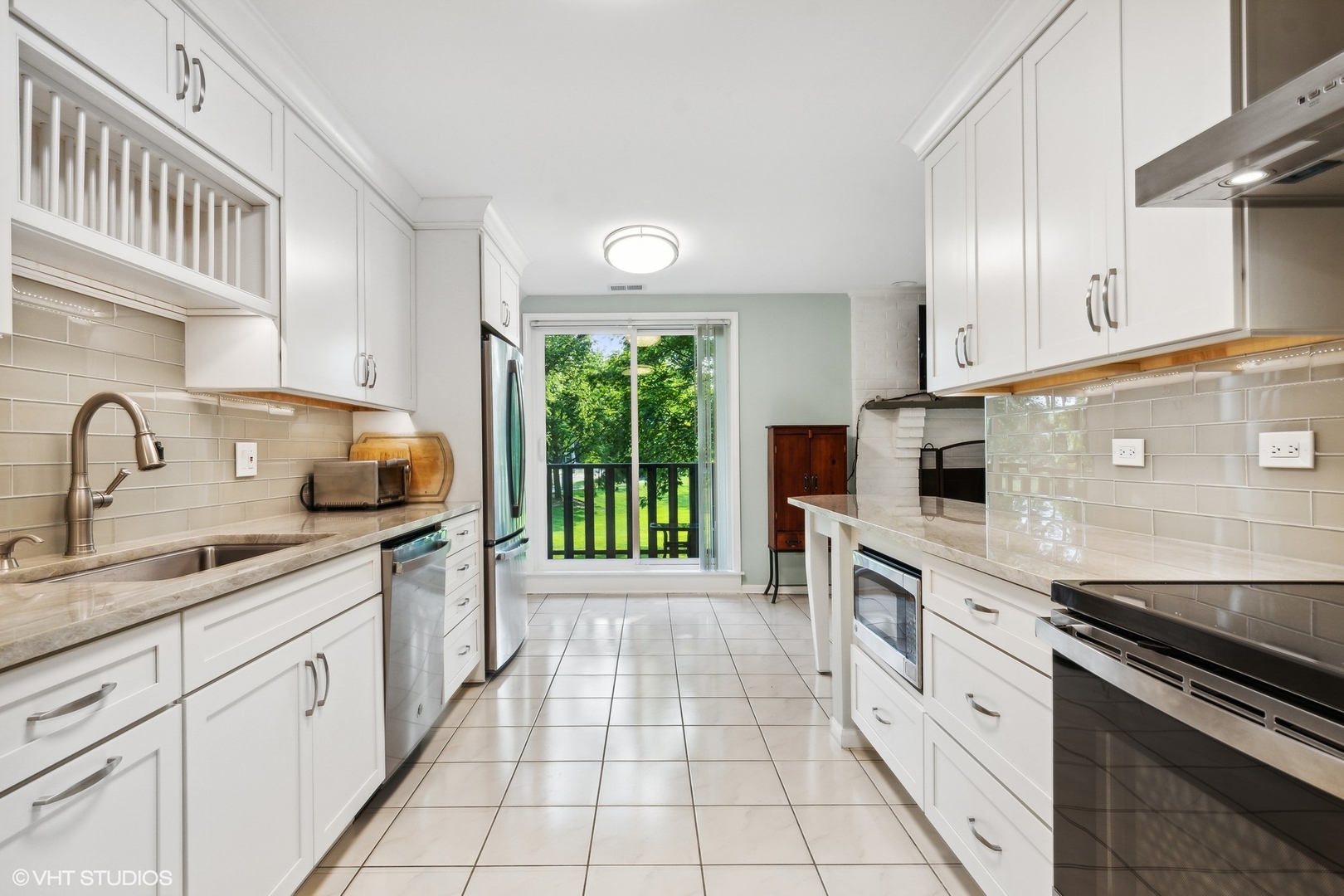 1175 Lake Cook Road, Unit 204 Northbrook, IL 60062 - Photo 8 of 20 a kitchen with a sink stove top oven and cabinets