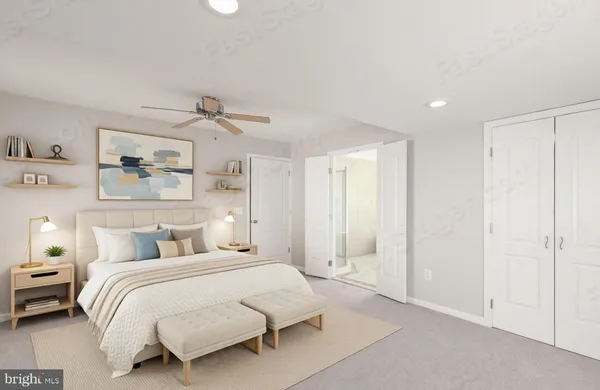 a bedroom with a large bed and a chandelier