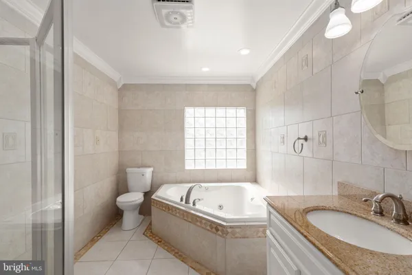 a bathroom with a bathtub a sink and a mirror