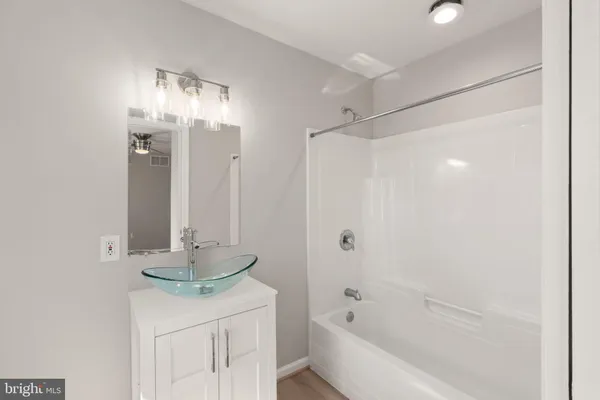 a view of a big room with wooden floor and windows in a room