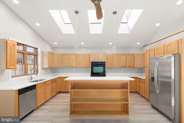 a kitchen with a refrigerator oven and a sink
