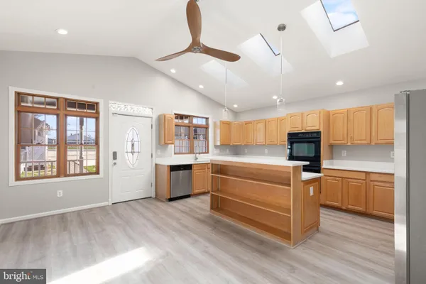 a kitchen with stainless steel appliances granite countertop a stove and a refrigerator