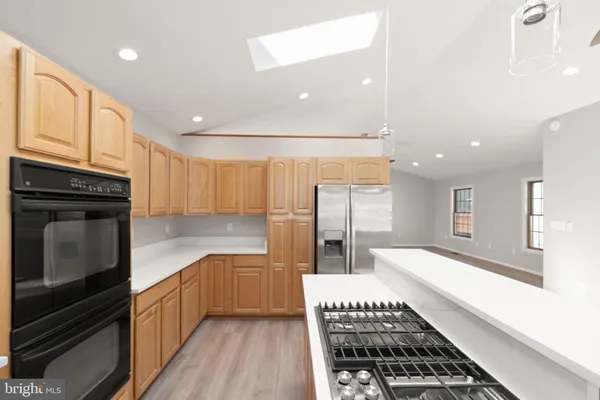 a kitchen with granite countertop stainless steel appliances and wooden cabinets
