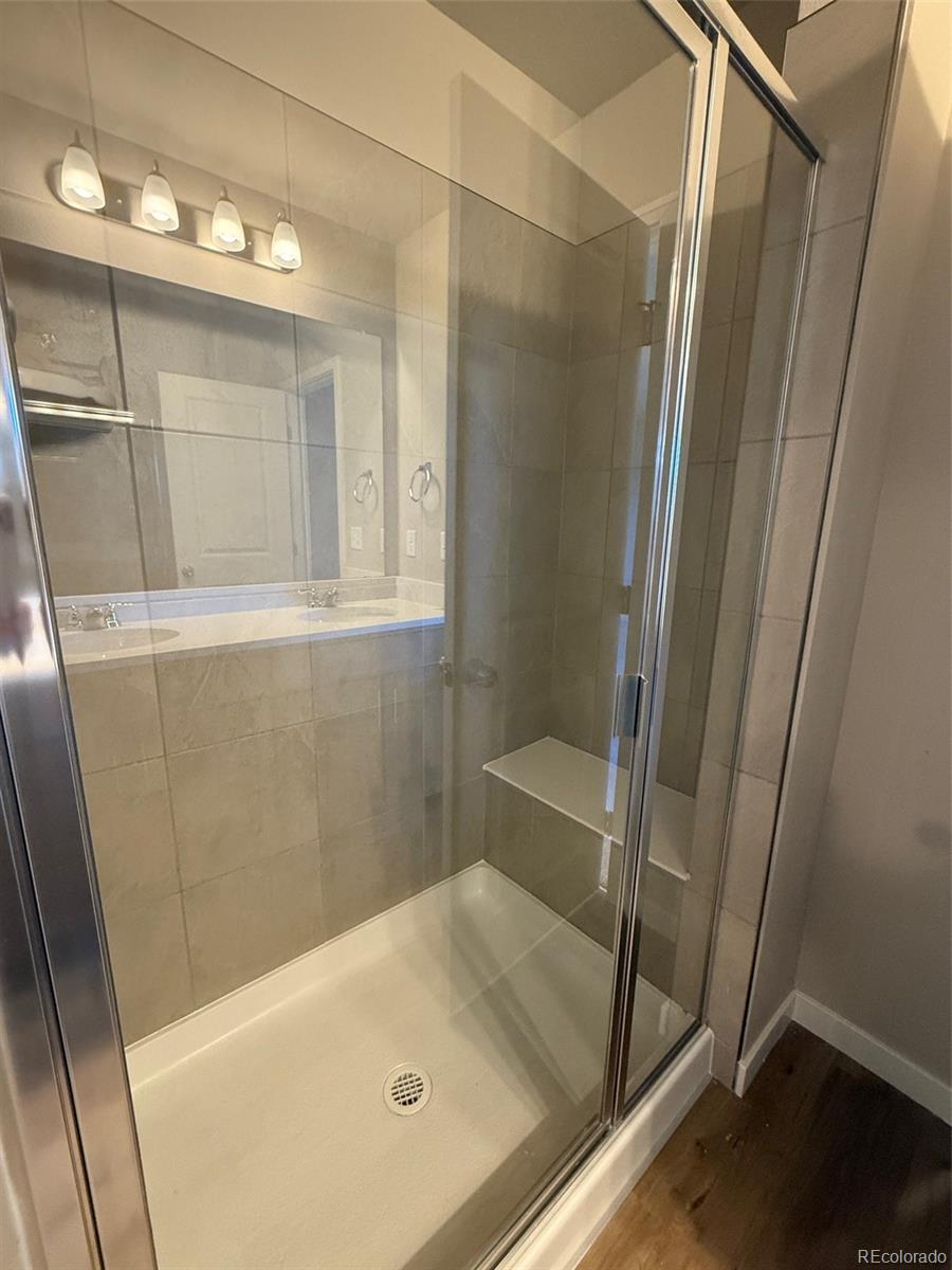 757 North Clubview Street Watkins, CO 80137 - Photo 14 of 24 a bathroom with a tub and shower