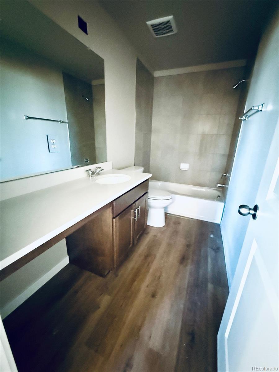 757 North Clubview Street Watkins, CO 80137 - Photo 16 of 24 a bathroom with a sink and a mirror