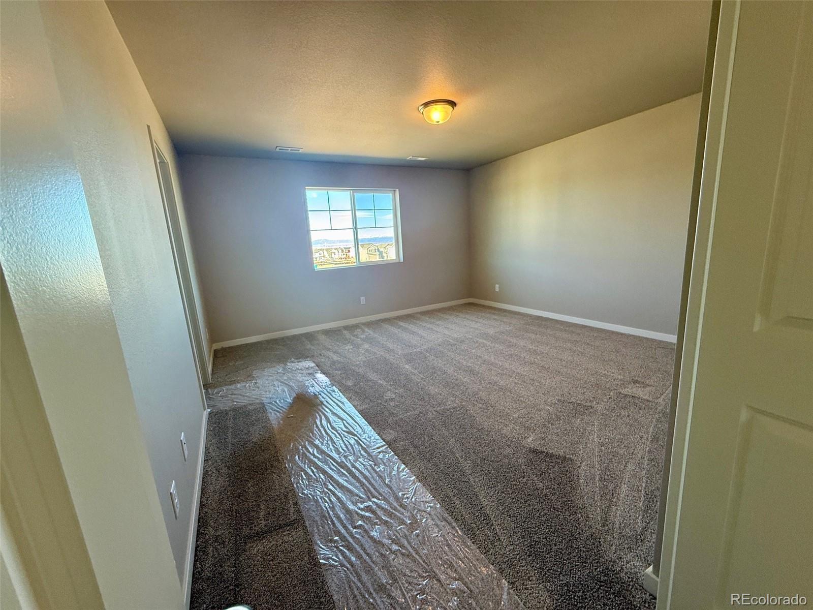 757 North Clubview Street Watkins, CO 80137 - Photo 21 of 24 an empty room with windows