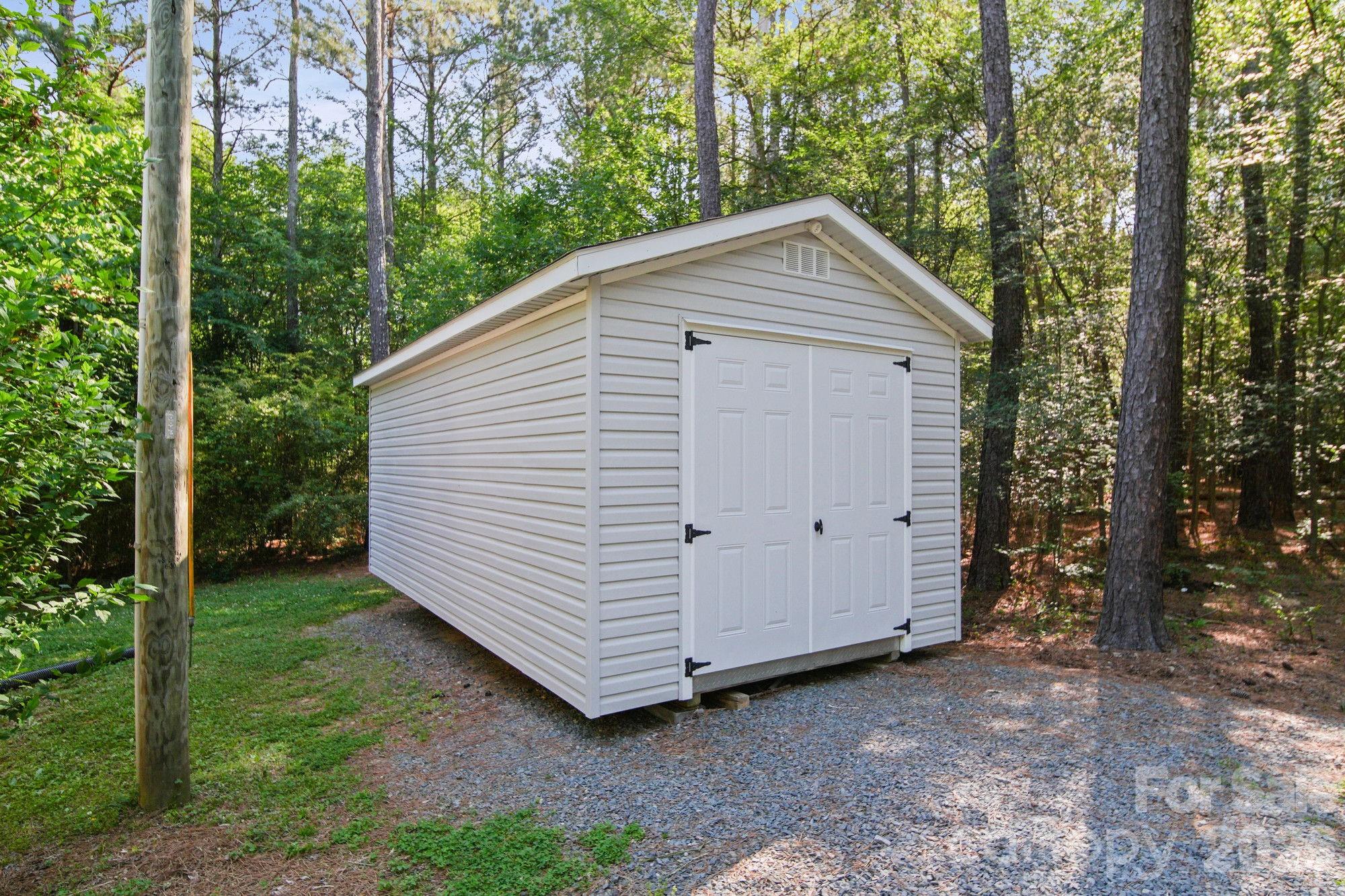 4507 White Store Road Wingate, NC 28174 - Photo 29 of 29 a view of a house with a yard and trees in the background