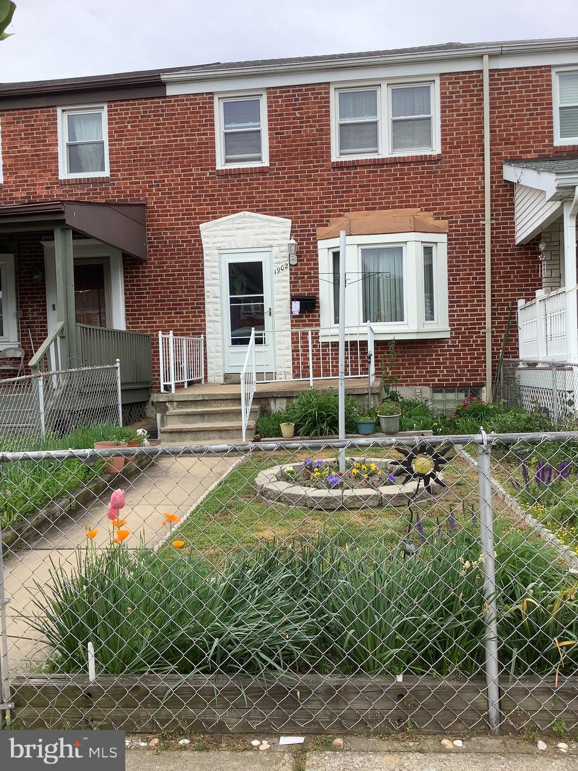 1902 Barry Road Baltimore, MD 21222 - Photo 2 of 34 a view of a brick house with a yard and plants