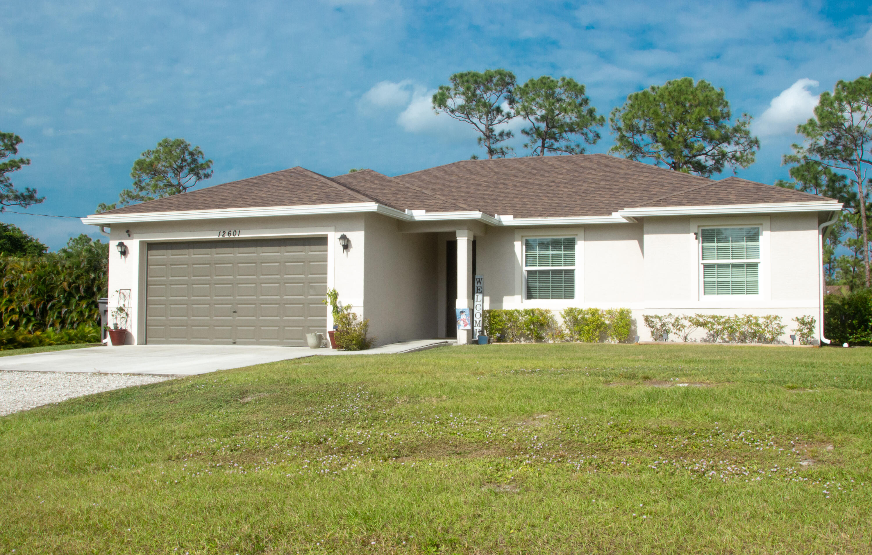 a front view of a house with a garden