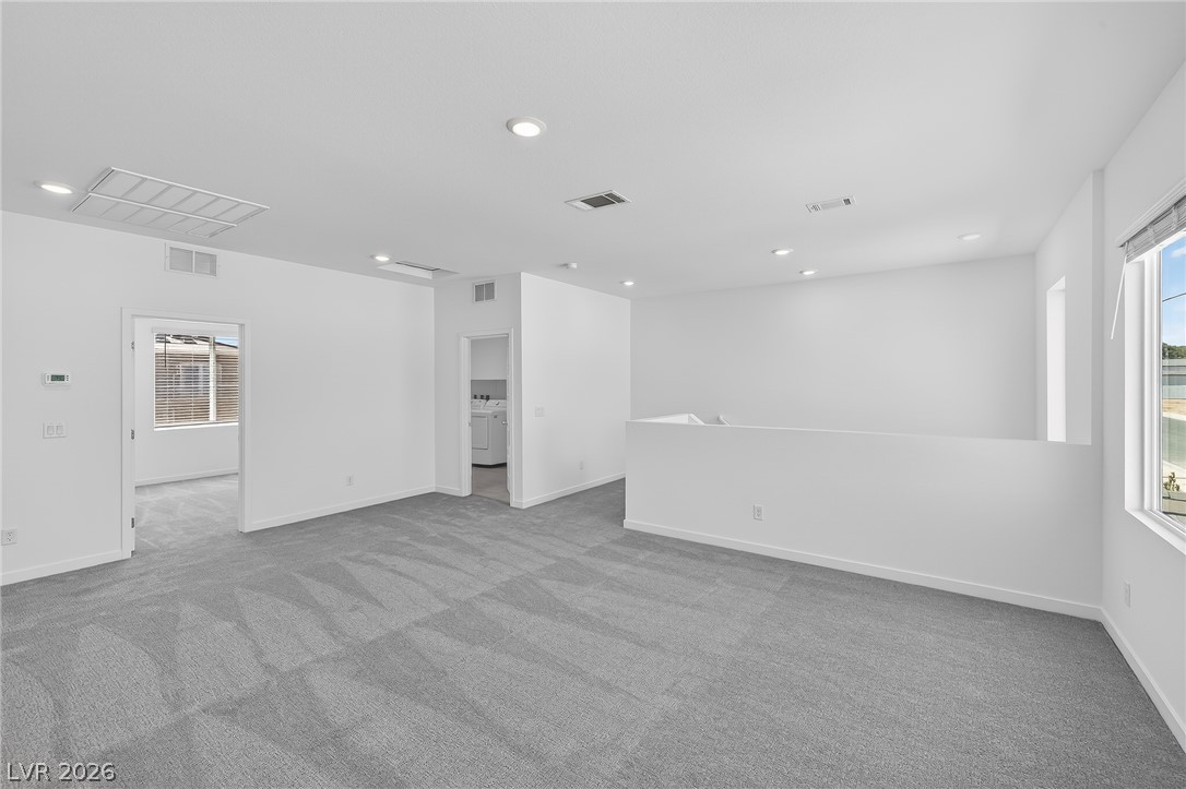 347 Sam Way Mesquite, NV 89027 - Photo 30 of 32 Bright, open living space with soft carpet, bathed in natural light from large windows.