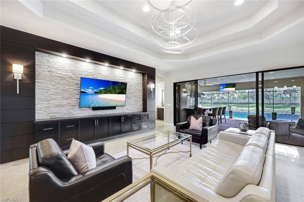 4394 Caldera Circle Naples, FL 34119 - Photo 1 of 39 a living room with furniture and a flat screen tv