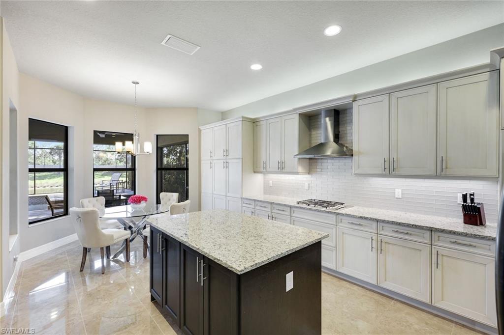 4394 Caldera Circle Naples, FL 34119 - Photo 11 of 39 a kitchen with a sink cabinets and wooden floor