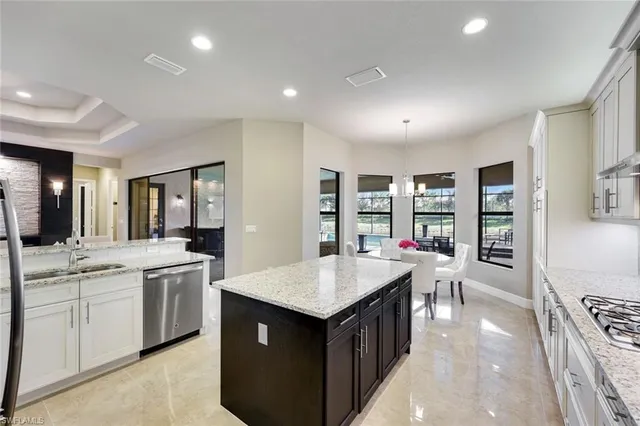 a kitchen with counter top space a sink cabinets and appliances