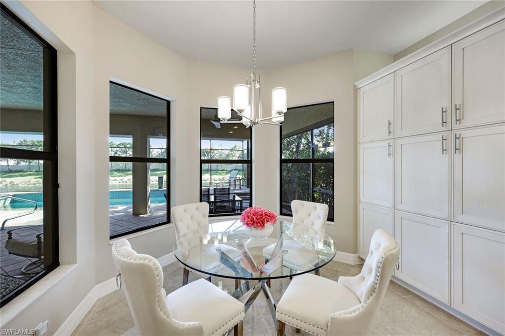 4394 Caldera Circle Naples, FL 34119 - Photo 13 of 39 a dining room with furniture a chandelier and window