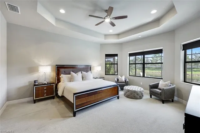 a spacious bedroom with a bed and a couch