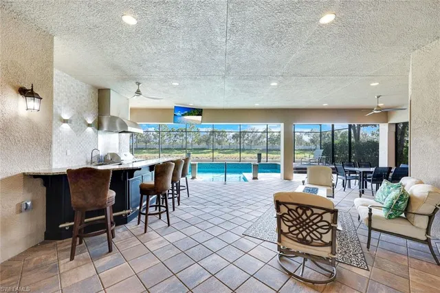 a living room with furniture a floor to ceiling window and floor to ceiling window