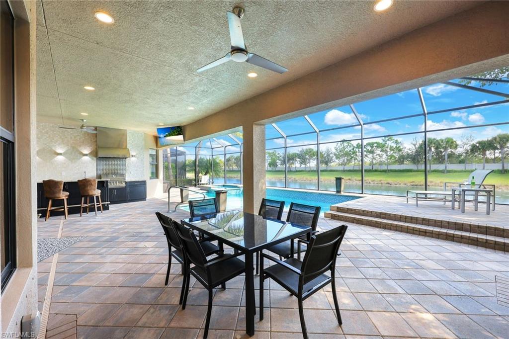 4394 Caldera Circle Naples, FL 34119 - Photo 29 of 39 a dining room with furniture and large windows