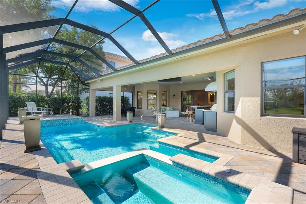 4394 Caldera Circle Naples, FL 34119 - Photo 31 of 39 a view of a patio with couches table and chairs