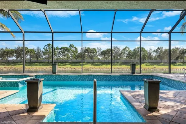 a view of a living room with a floor to ceiling window and wooden floor