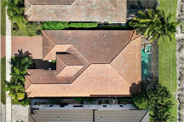 an aerial view of a house with a yard and potted plants