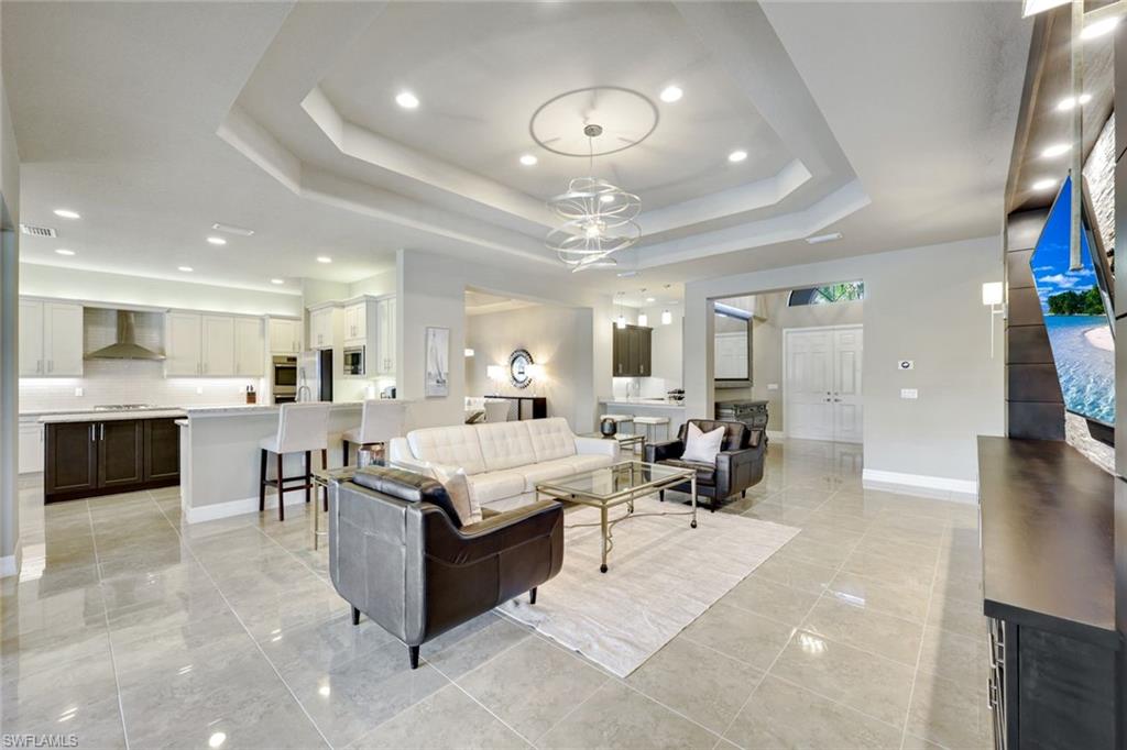 4394 Caldera Circle Naples, FL 34119 - Photo 7 of 39 a living room with stainless steel appliances kitchen island furniture and a view of kitchen