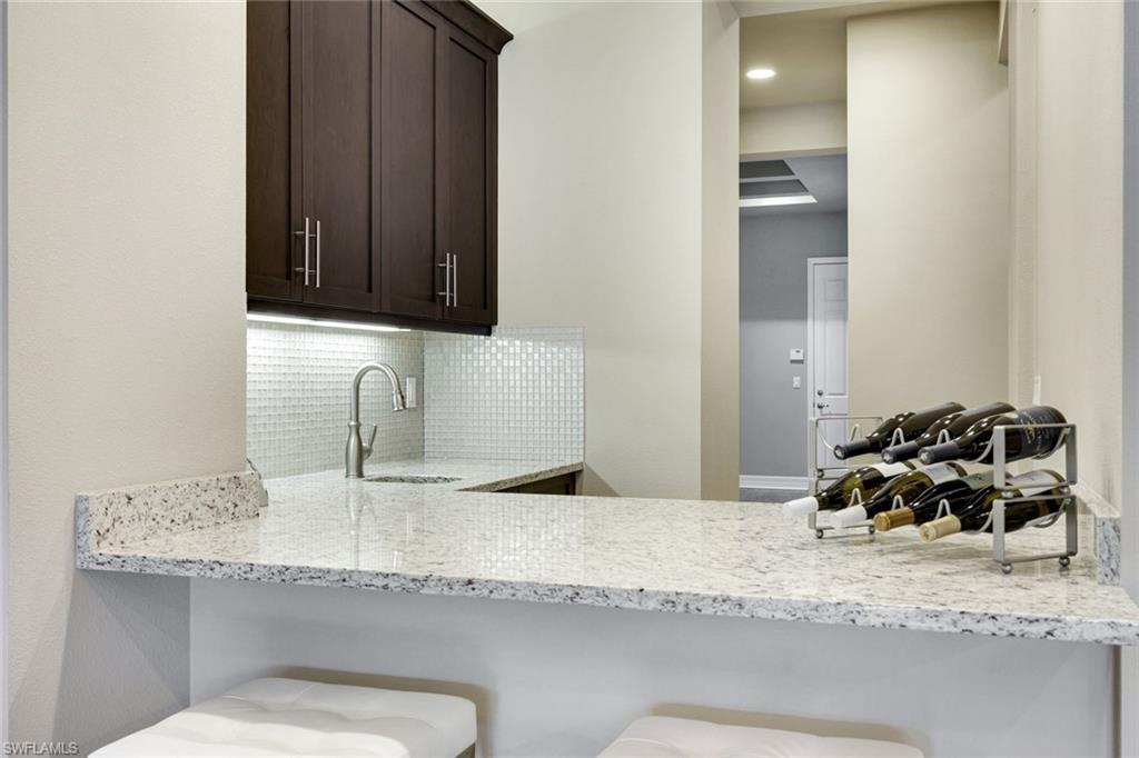 4394 Caldera Circle Naples, FL 34119 - Photo 8 of 39 a bathroom with a granite countertop sink and a mirror