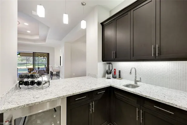 a kitchen with granite countertop stainless steel appliances a sink and cabinets