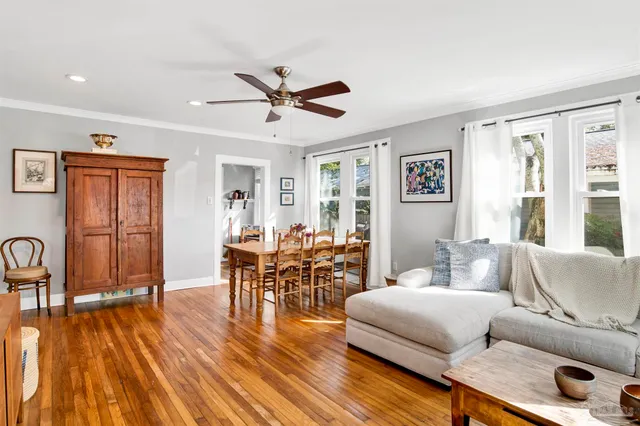 a living room with furniture and a wooden floor