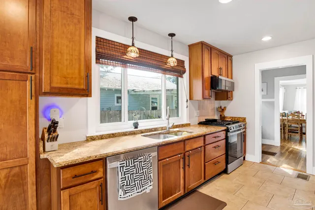 a kitchen with granite countertop a sink and a stove