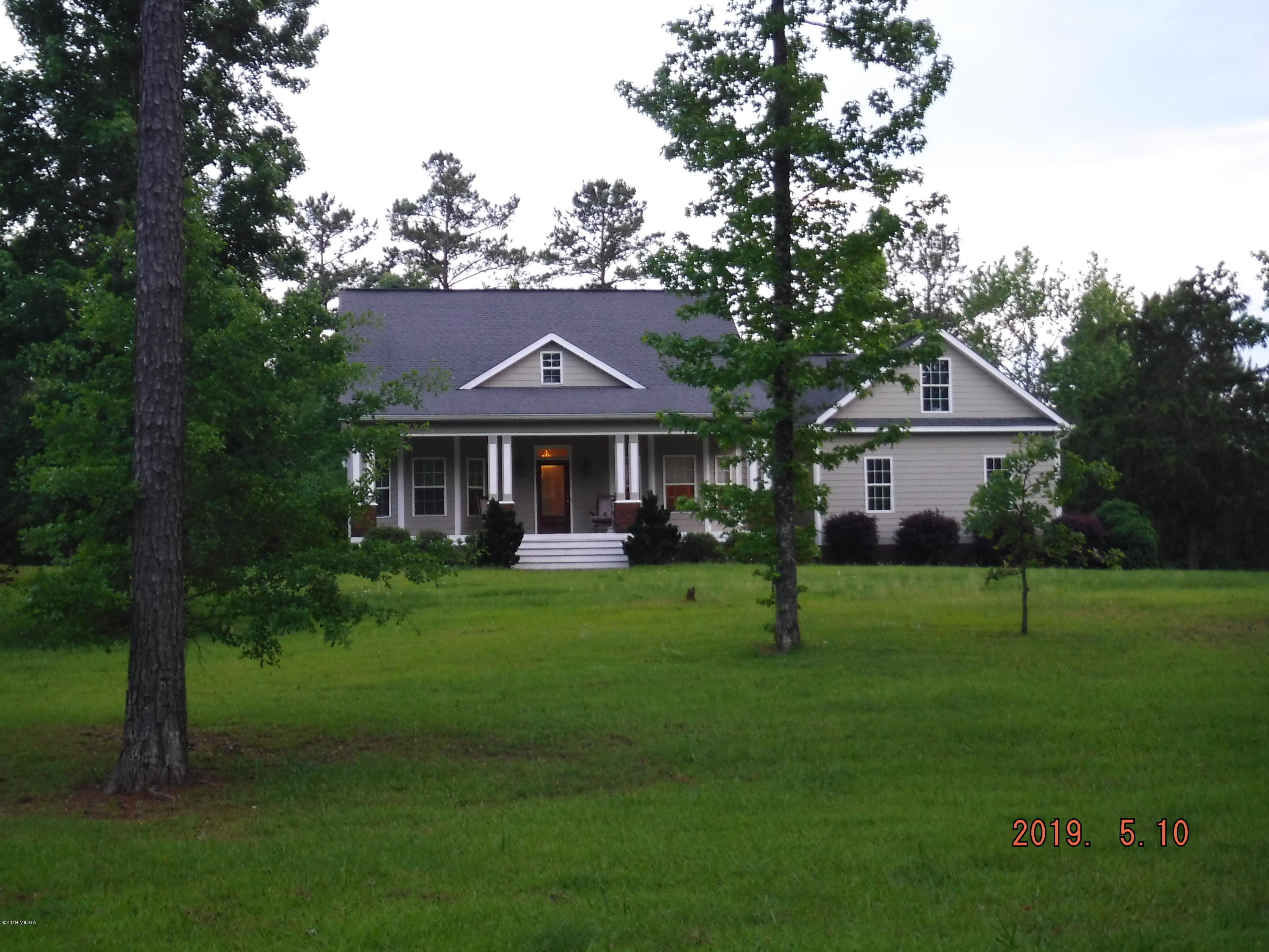 755 Charles Johnson Road Forsyth, GA 31029 - Photo 2 of 35 a front view of a house with a yard