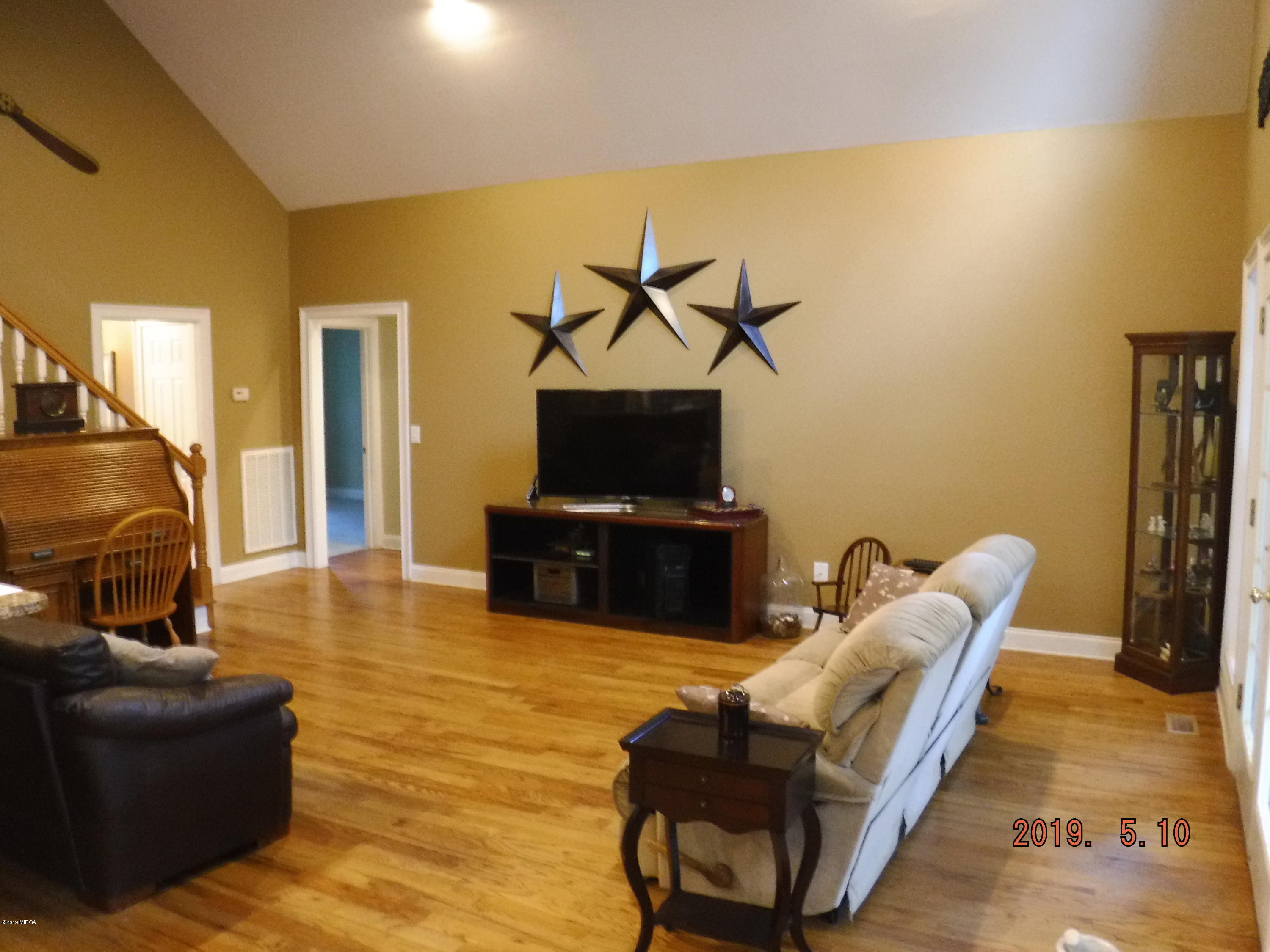 755 Charles Johnson Road Forsyth, GA 31029 - Photo 11 of 35 a living room with furniture and a flat screen tv