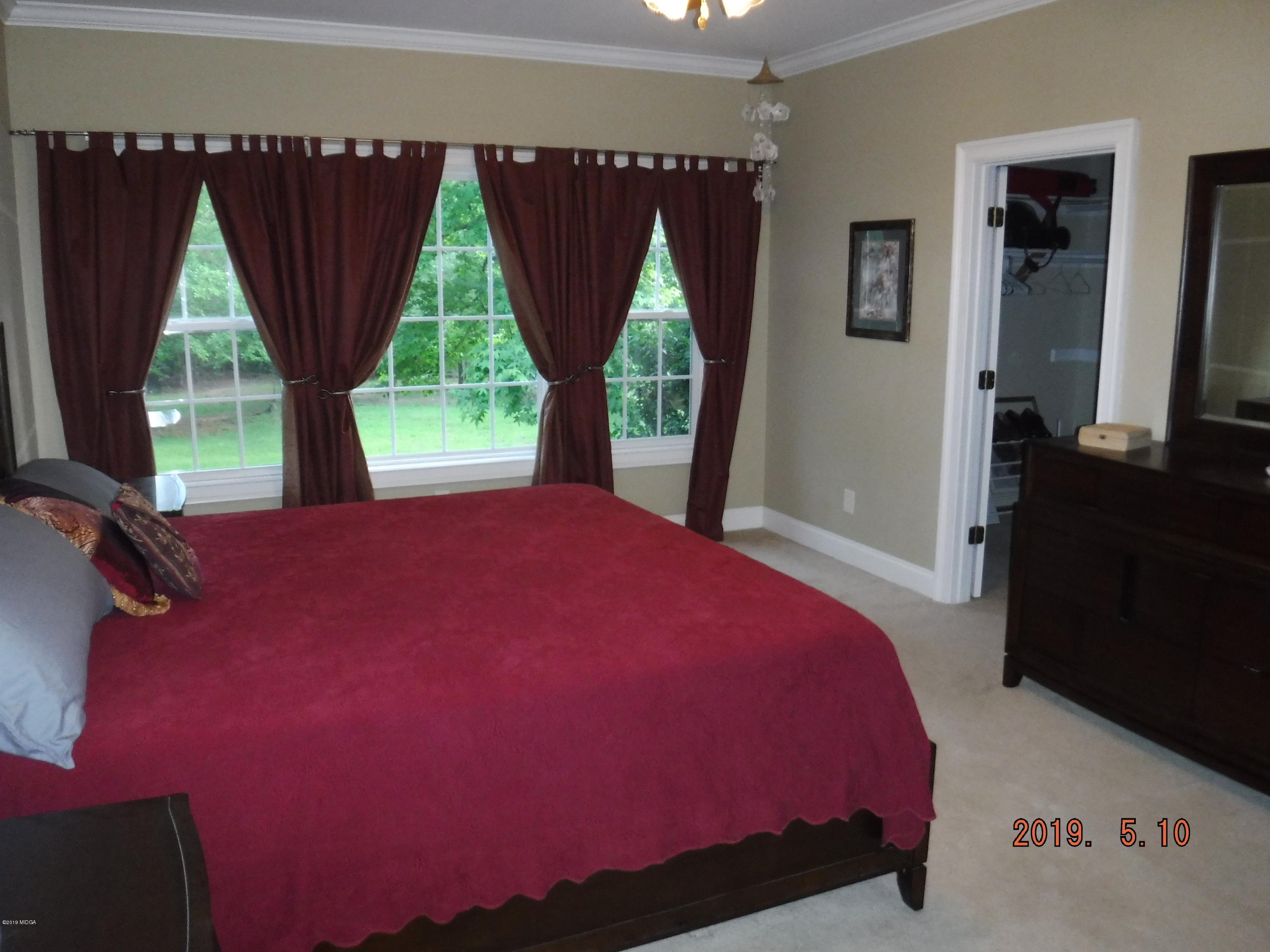 755 Charles Johnson Road Forsyth, GA 31029 - Photo 12 of 35 a bedroom with a bed and window
