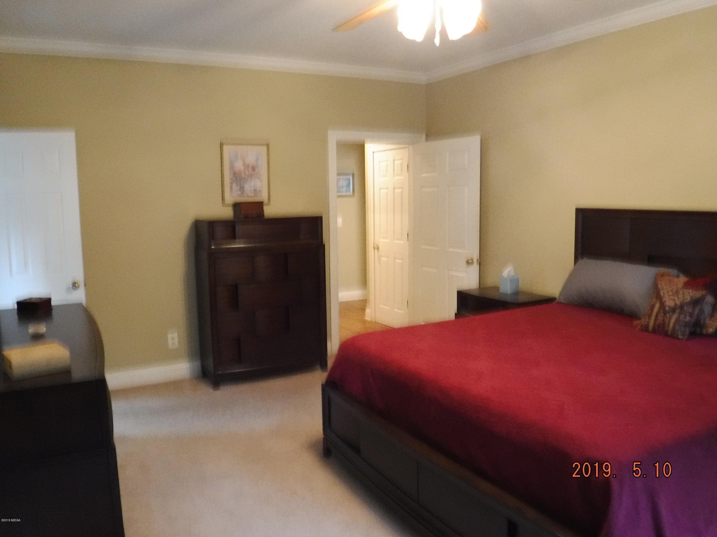 755 Charles Johnson Road Forsyth, GA 31029 - Photo 13 of 35 a bedroom with a bed and a closet