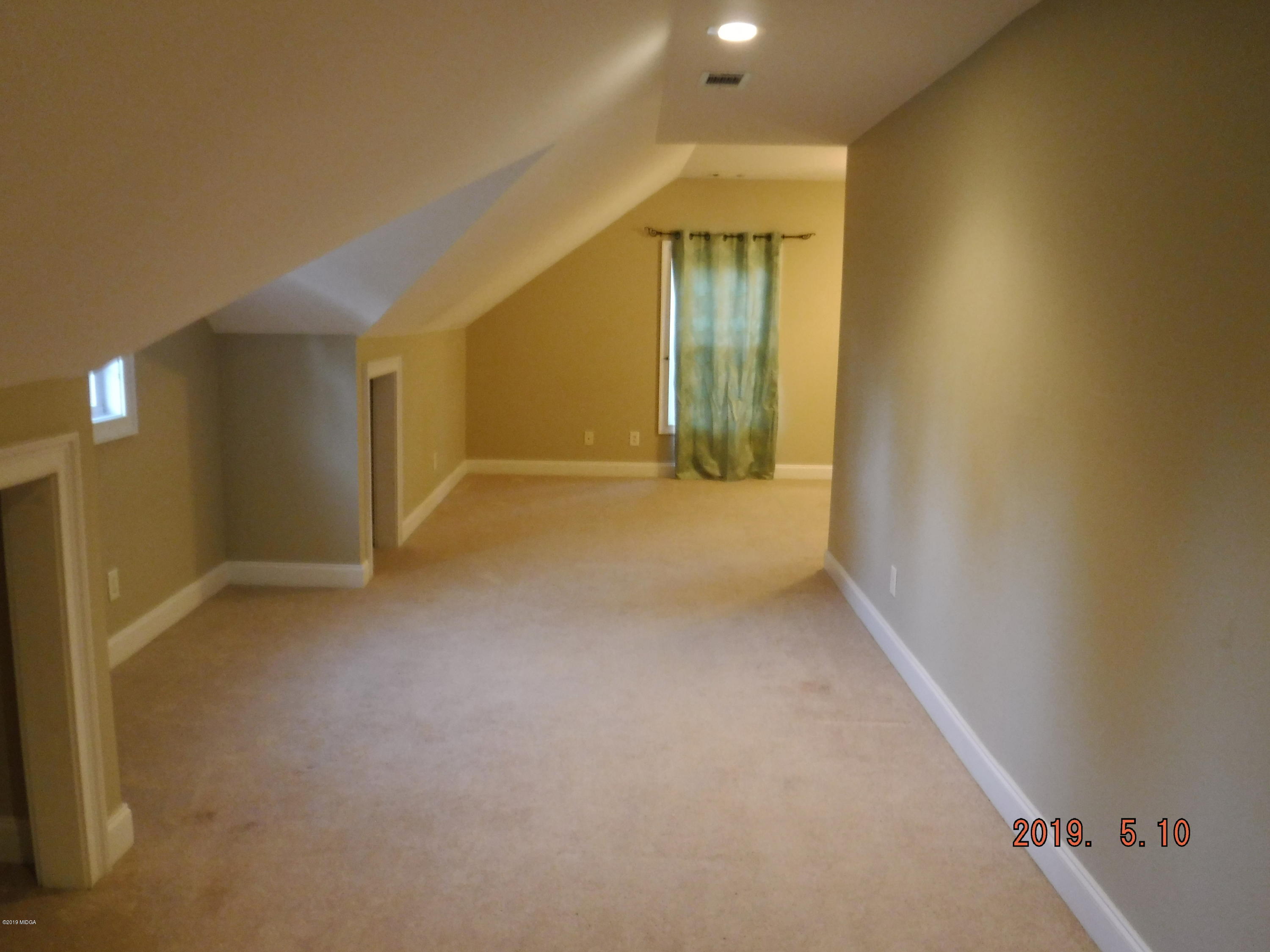 755 Charles Johnson Road Forsyth, GA 31029 - Photo 18 of 35 a view of an empty room with a fireplace