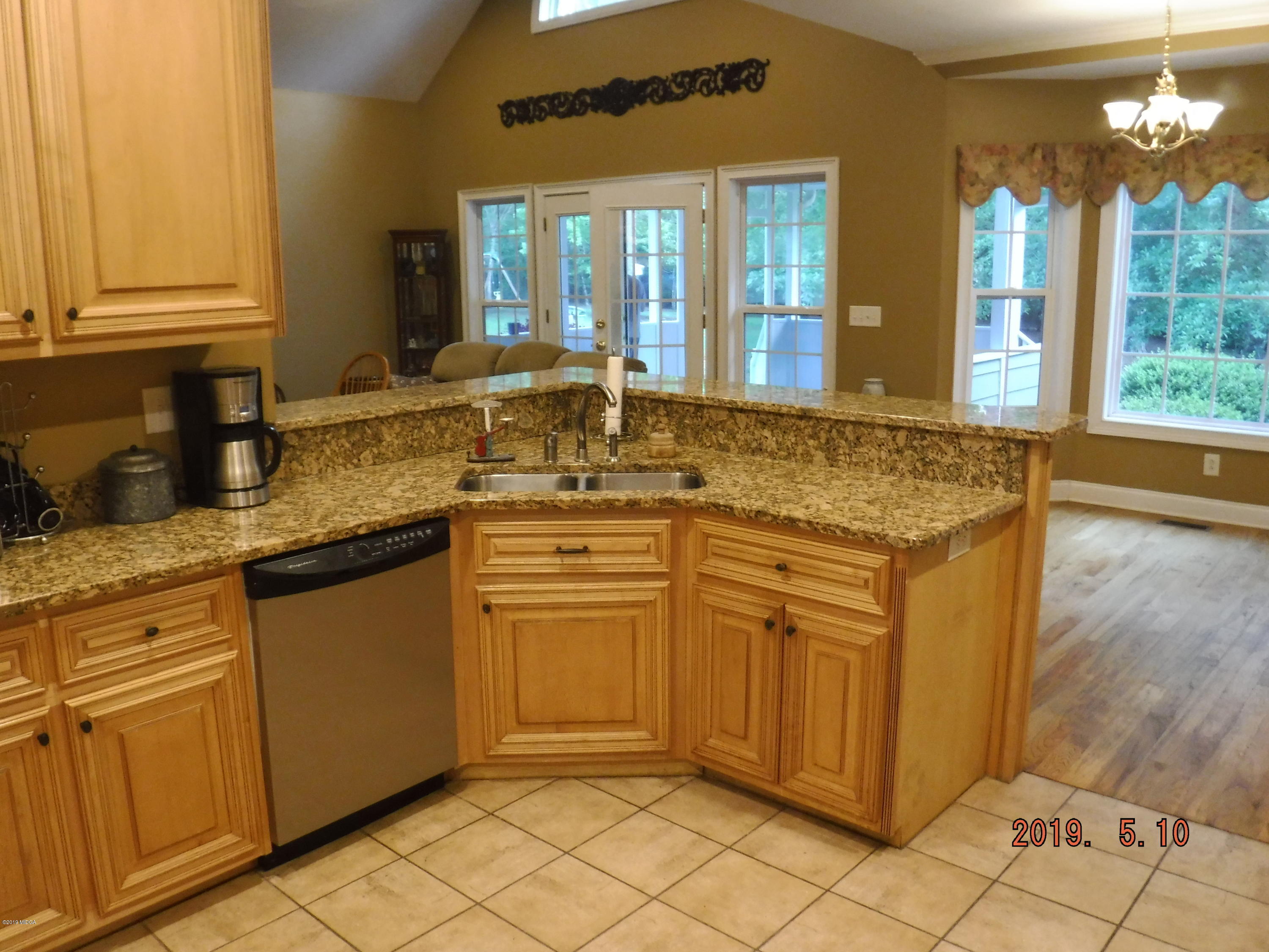 755 Charles Johnson Road Forsyth, GA 31029 - Photo 3 of 35 a kitchen with stainless steel appliances granite countertop a sink and cabinets