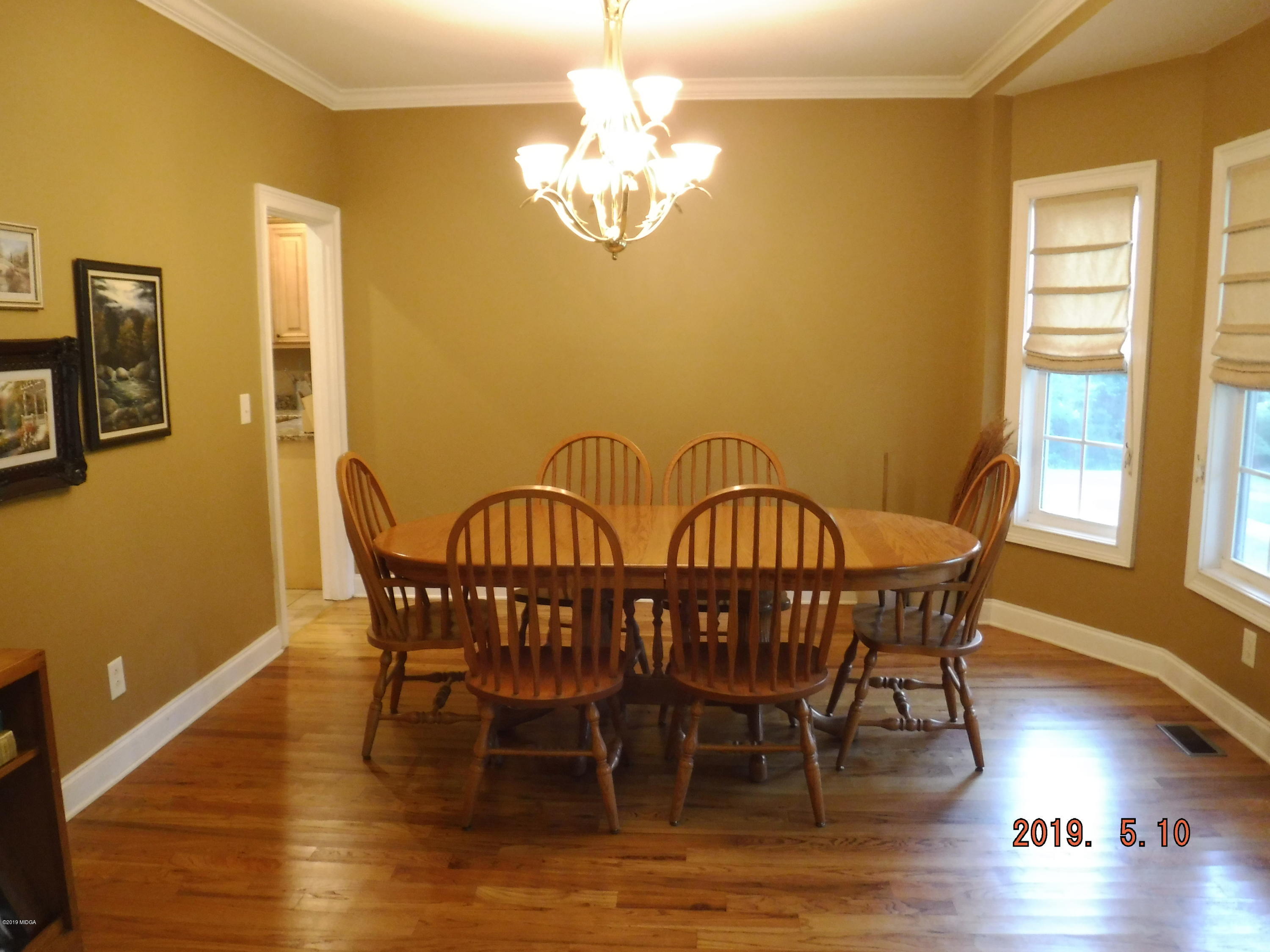 755 Charles Johnson Road Forsyth, GA 31029 - Photo 22 of 35 a view of a dining room with furniture window and wooden floor