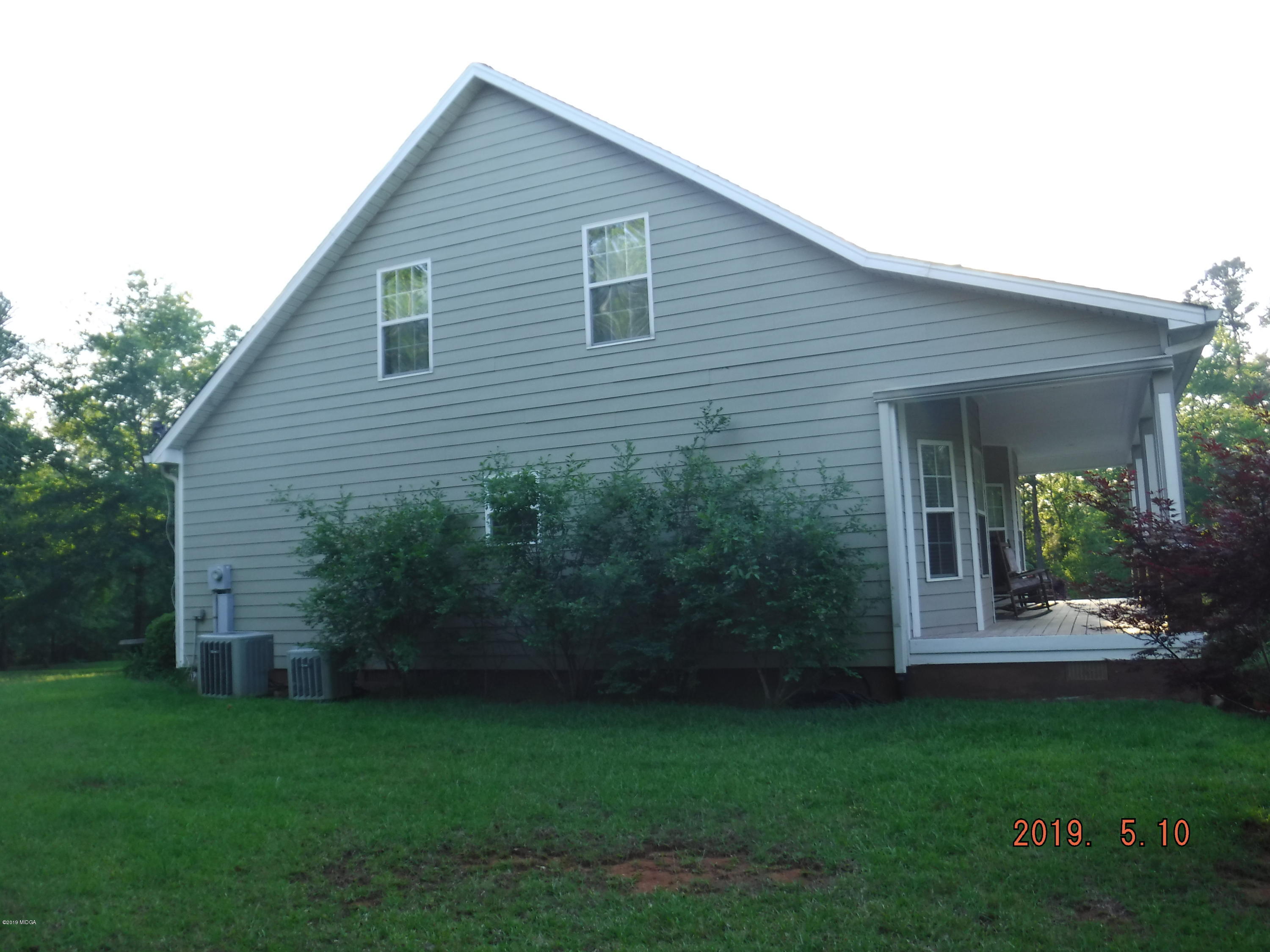 755 Charles Johnson Road Forsyth, GA 31029 - Photo 28 of 35 a view of a house with backyard and garden