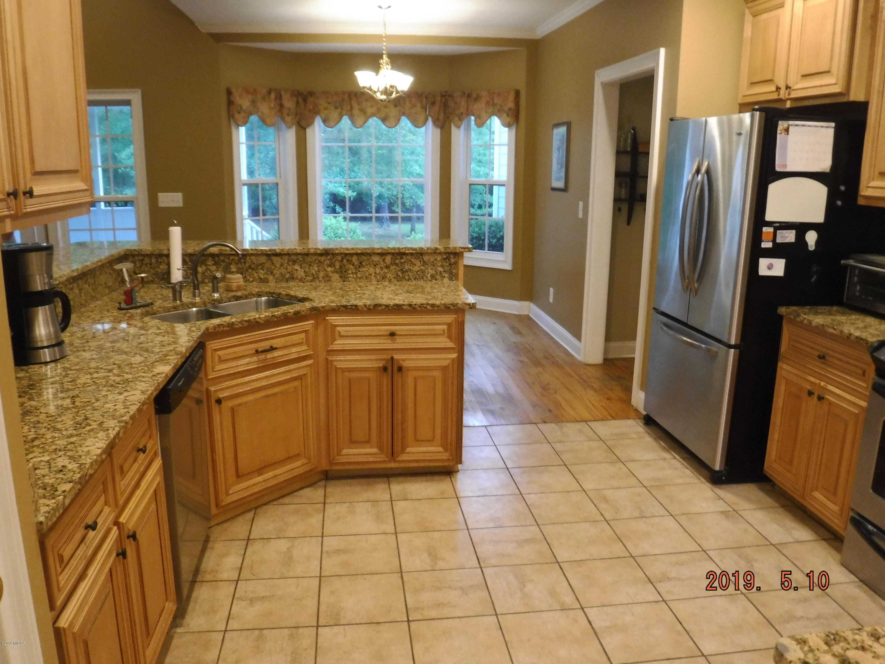 755 Charles Johnson Road Forsyth, GA 31029 - Photo 4 of 35 a kitchen with stainless steel appliances granite countertop a refrigerator and a sink
