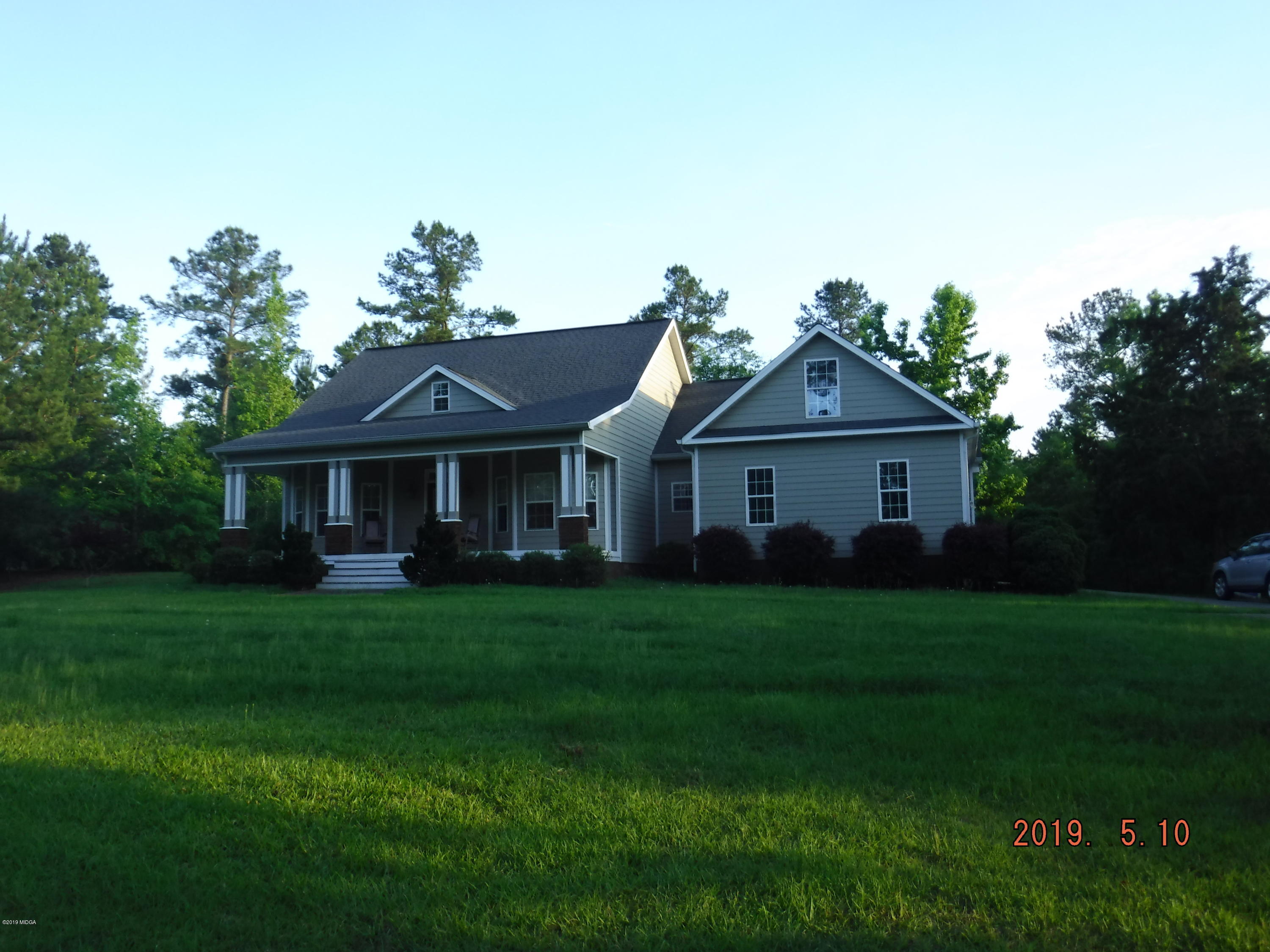 755 Charles Johnson Road Forsyth, GA 31029 - Photo 31 of 35 a front view of a house with a garden