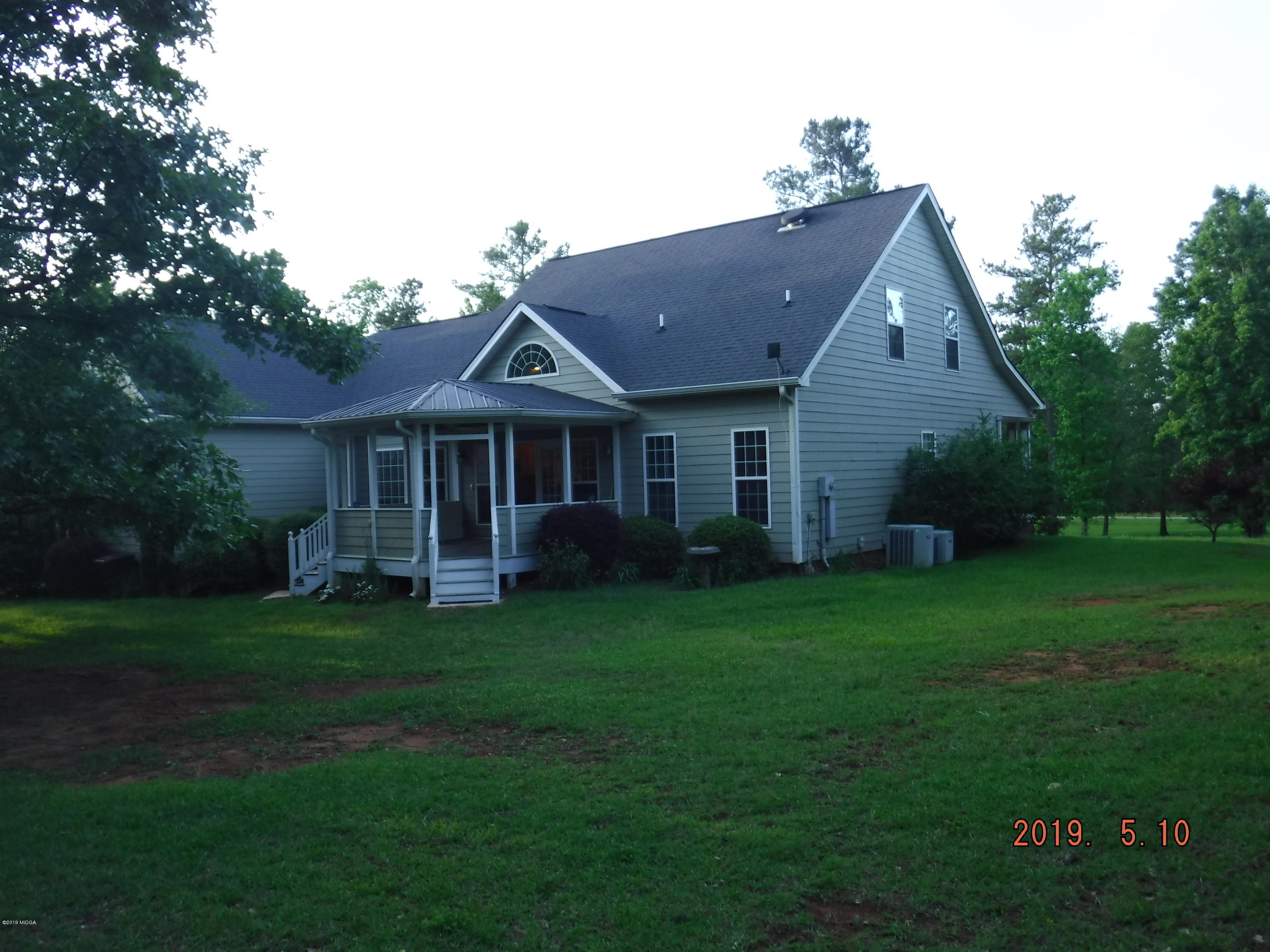 755 Charles Johnson Road Forsyth, GA 31029 - Photo 34 of 35 a front view of a house with a garden
