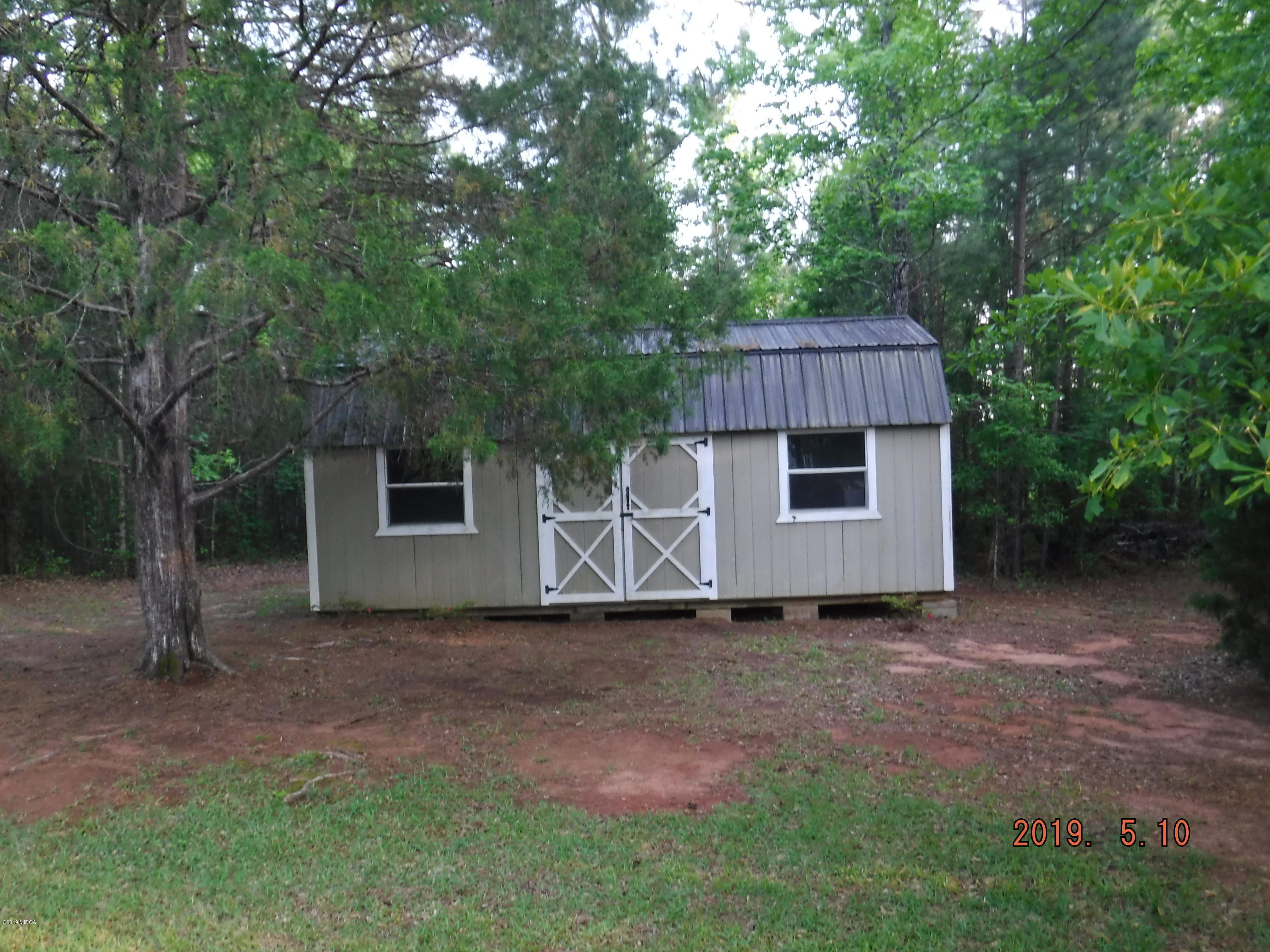 755 Charles Johnson Road Forsyth, GA 31029 - Photo 35 of 35 a house with trees in front of it