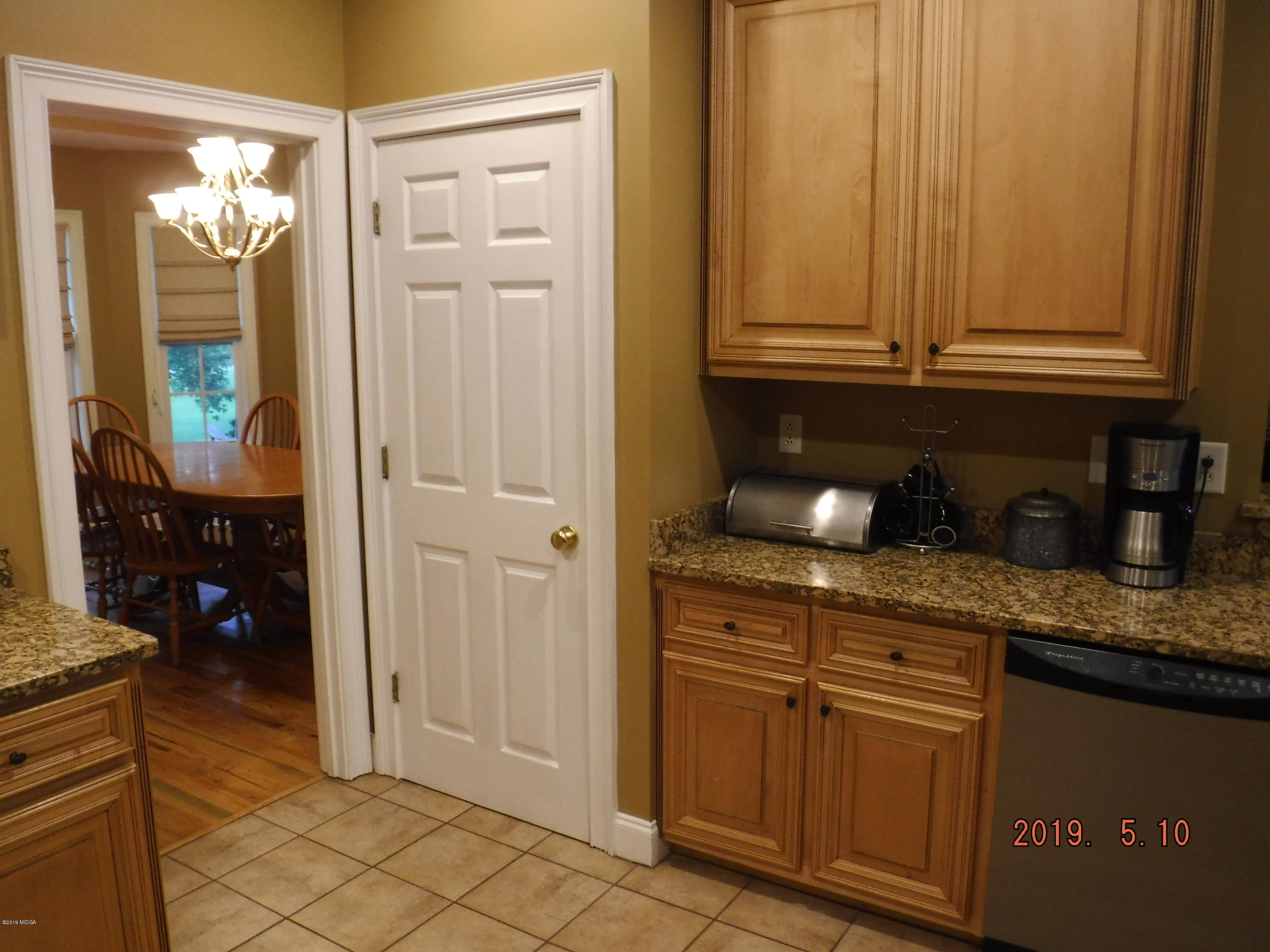 755 Charles Johnson Road Forsyth, GA 31029 - Photo 5 of 35 a kitchen with granite countertop cabinets and granite counter tops