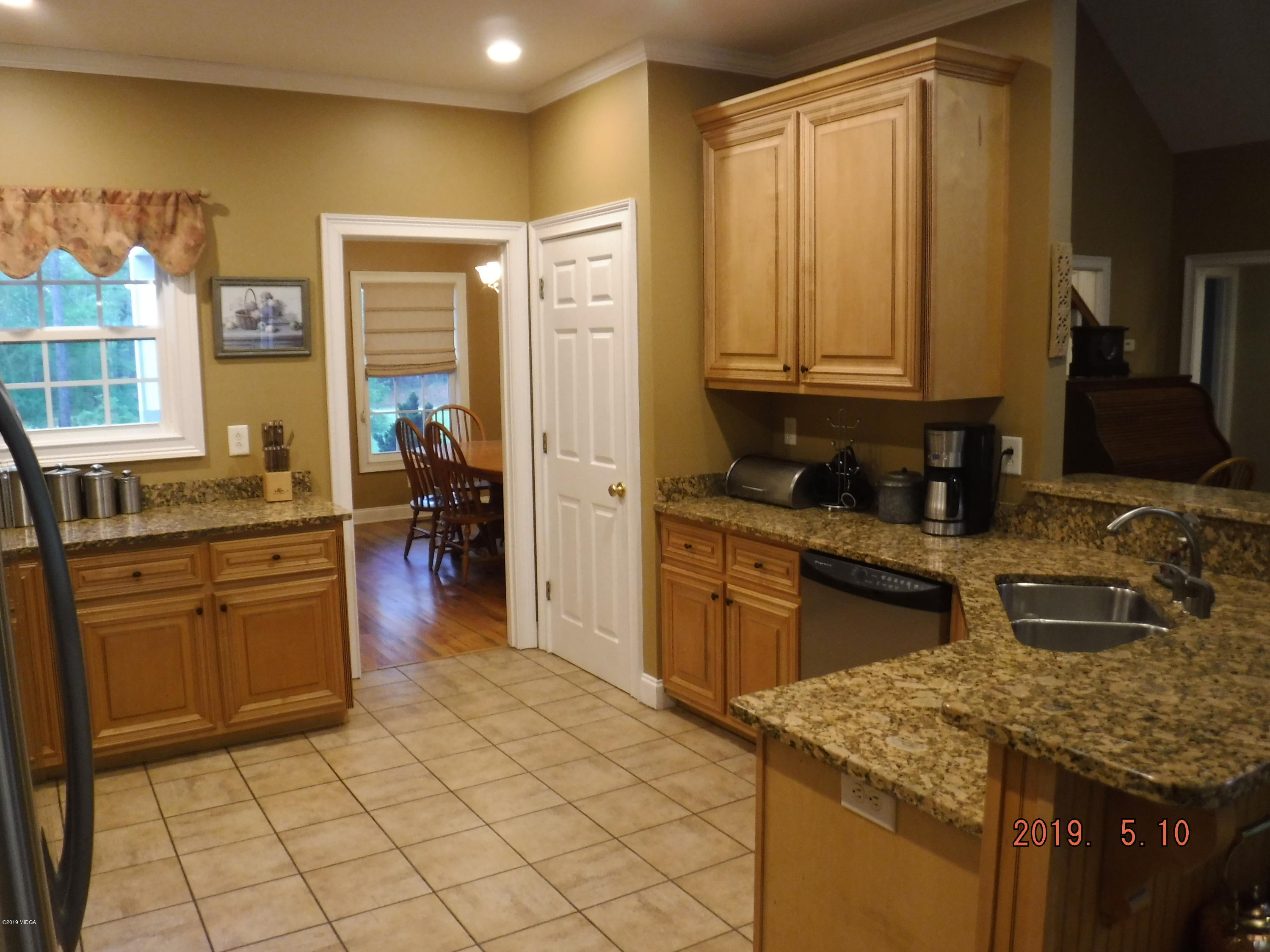 755 Charles Johnson Road Forsyth, GA 31029 - Photo 8 of 35 a kitchen with stainless steel appliances granite countertop a sink stove and refrigerator