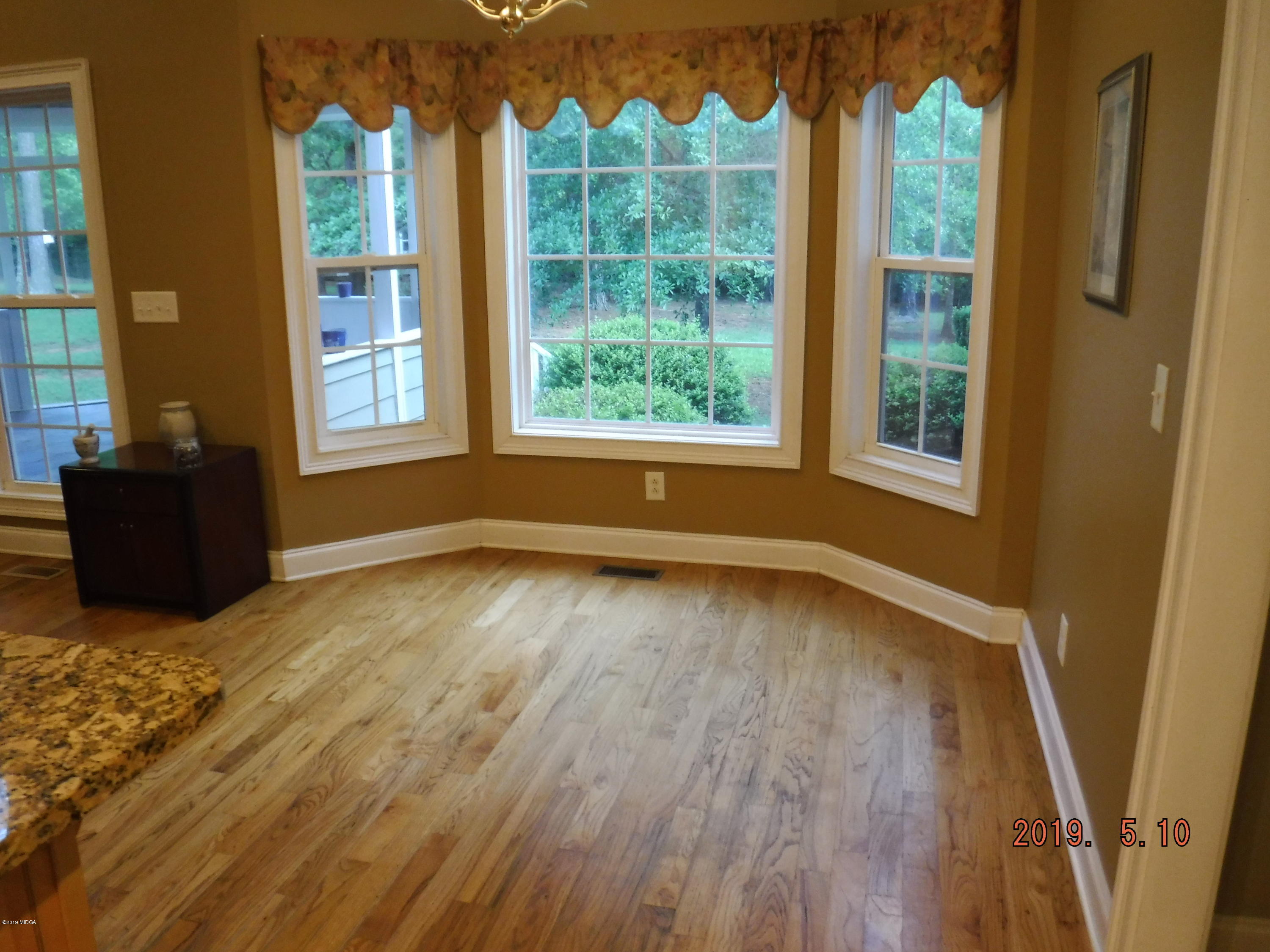755 Charles Johnson Road Forsyth, GA 31029 - Photo 9 of 35 wooden floor in an empty room with a window