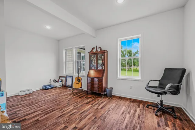 a view of a workspace with furniture and a window