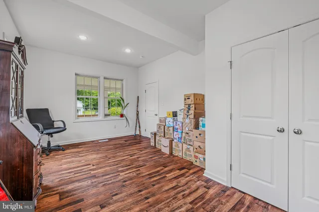 a view of a hallway with workspace and a window