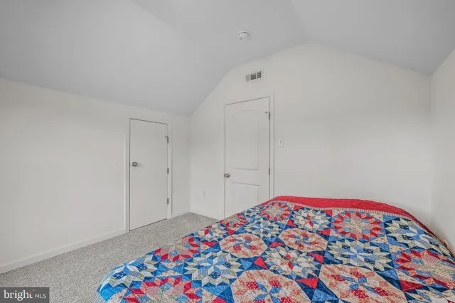 a bedroom with a bed and a book shelf