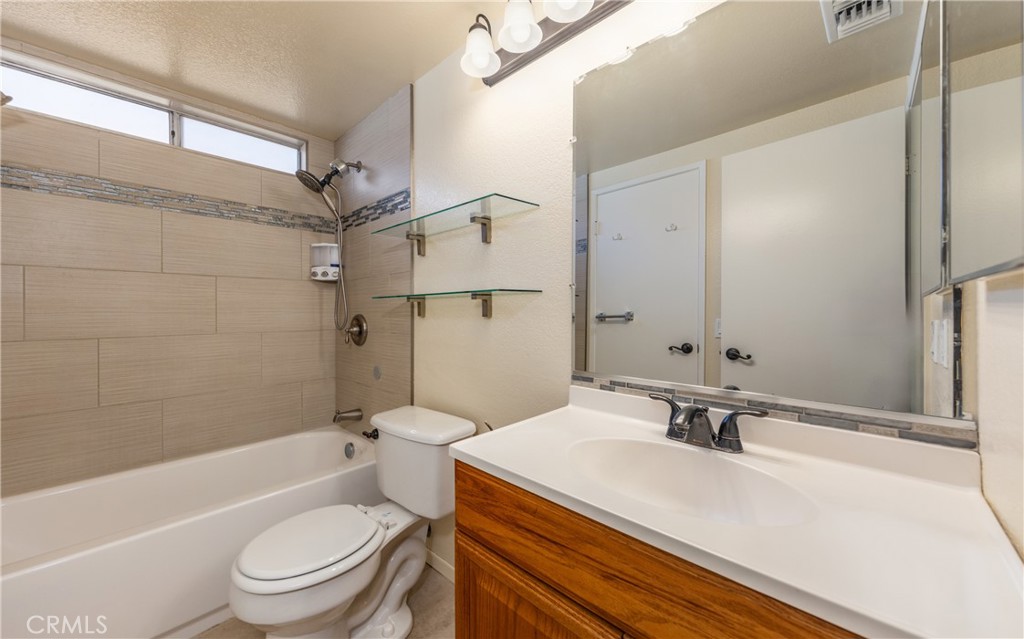 1954 Union Street Colton, CA 92324 - Photo 14 of 32 a bathroom with a sink toilet vanity and shower